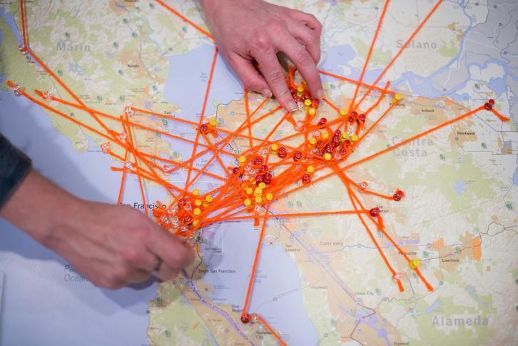 A Bay Area map with orange yarn, mapping residents work, home and leisure locations.