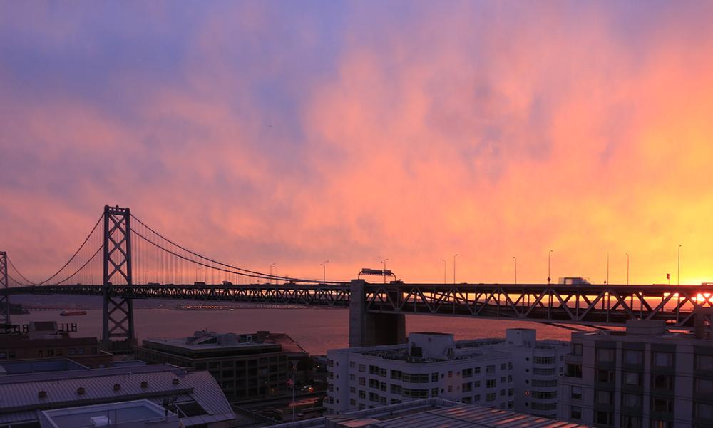 Sunrise behind the San Francisco-Oakland Bay Bridge.
